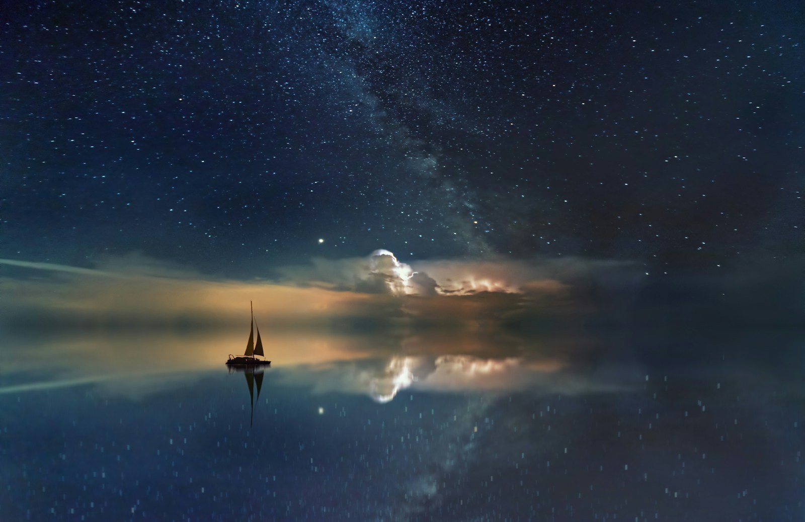 A solitary figure beneath a cosmic sky